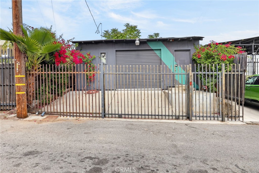 9939 Commerce Avenue Tujunga, CA 91042 - Photo 1 of 30 a view of a house with a fence and a garage