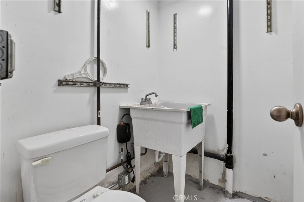 9939 Commerce Avenue Tujunga, CA 91042 - Photo 16 of 30 a bathroom with a sink toilet and a mirror