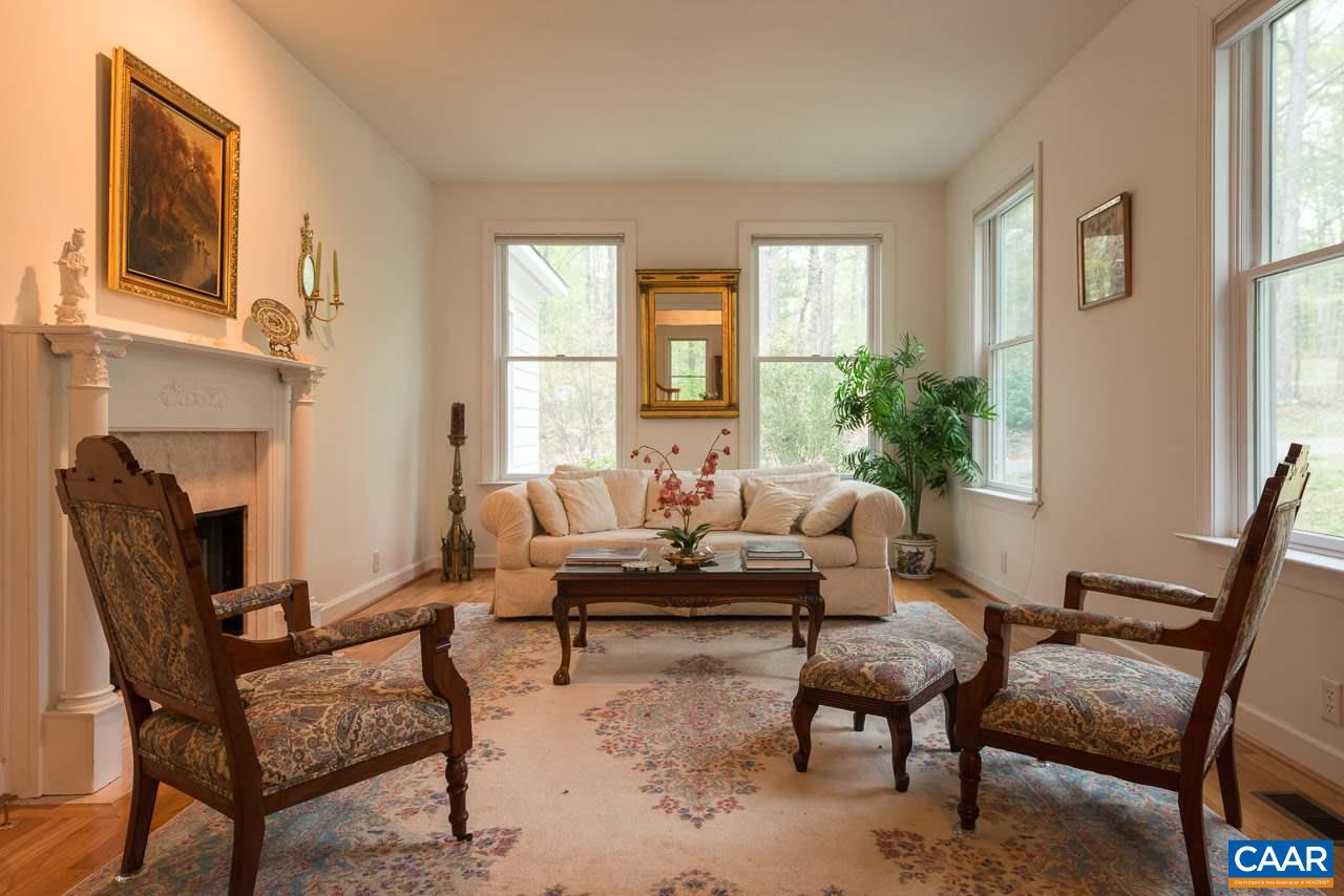 680 Broad Axe Road Charlottesville, VA 22903 - Photo 3 of 19 a living room with furniture and a potted plant next to a window