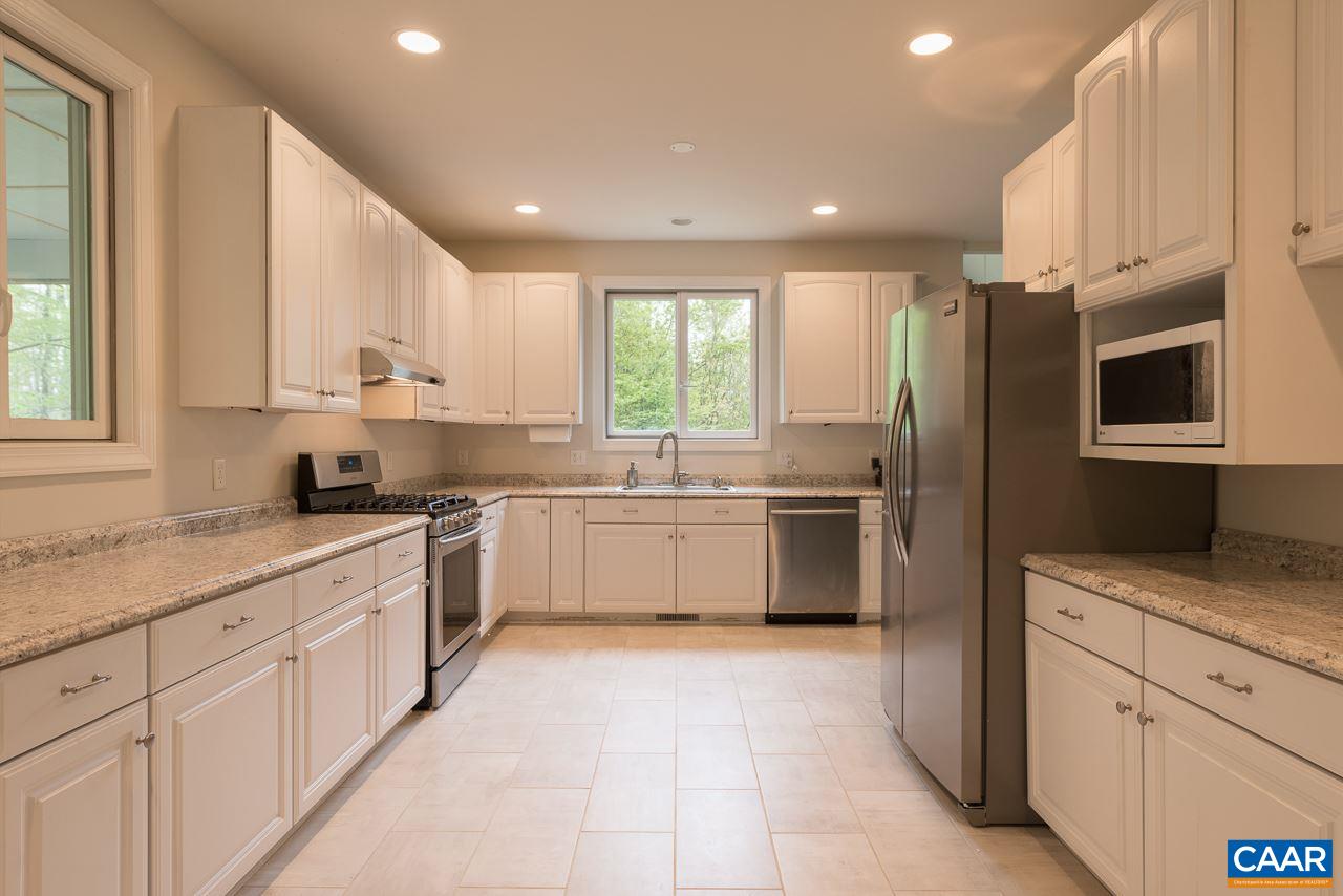 680 Broad Axe Road Charlottesville, VA 22903 - Photo 5 of 19 a kitchen with granite countertop white cabinets and white stainless steel appliances