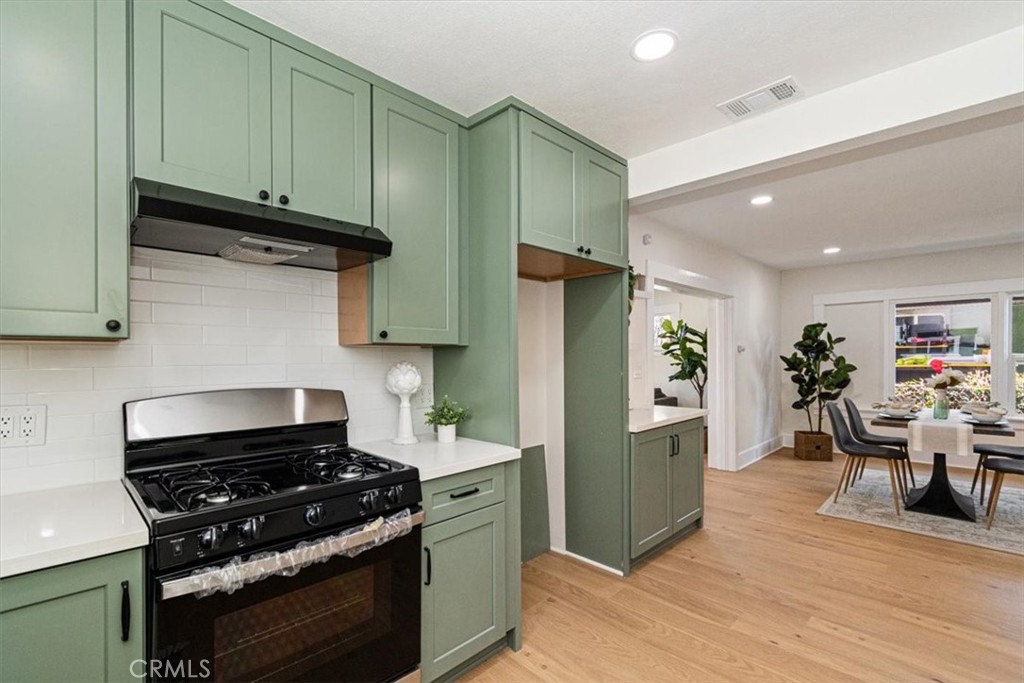 4474 Highland Place Riverside, CA 92506 - Photo 11 of 31 a kitchen with stainless steel appliances granite countertop a refrigerator and a stove top oven