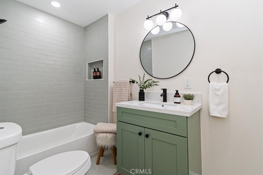 4474 Highland Place Riverside, CA 92506 - Photo 20 of 31 a bathroom with a toilet sink and mirror