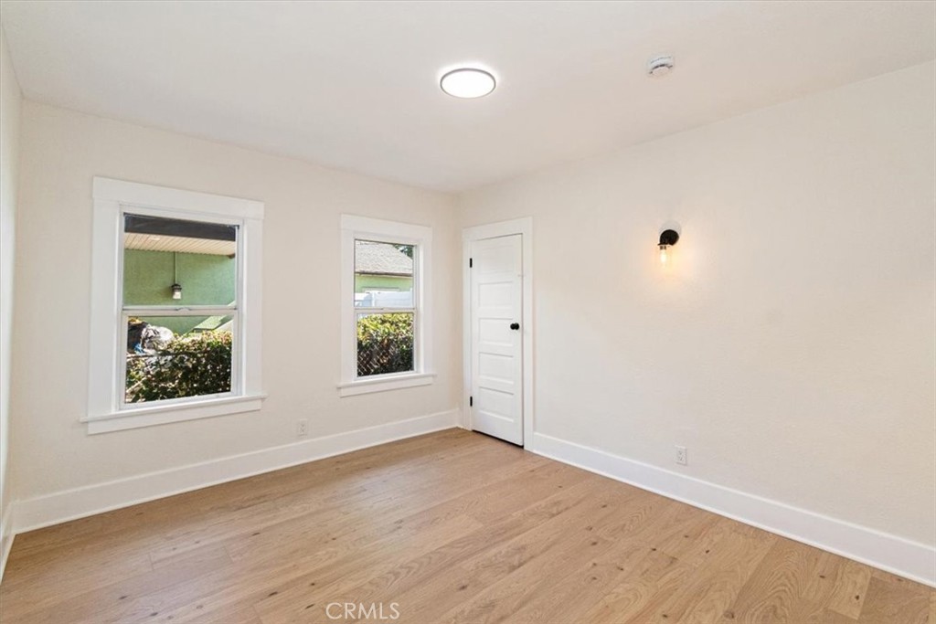 4474 Highland Place Riverside, CA 92506 - Photo 21 of 31 an empty room with wooden floor and windows