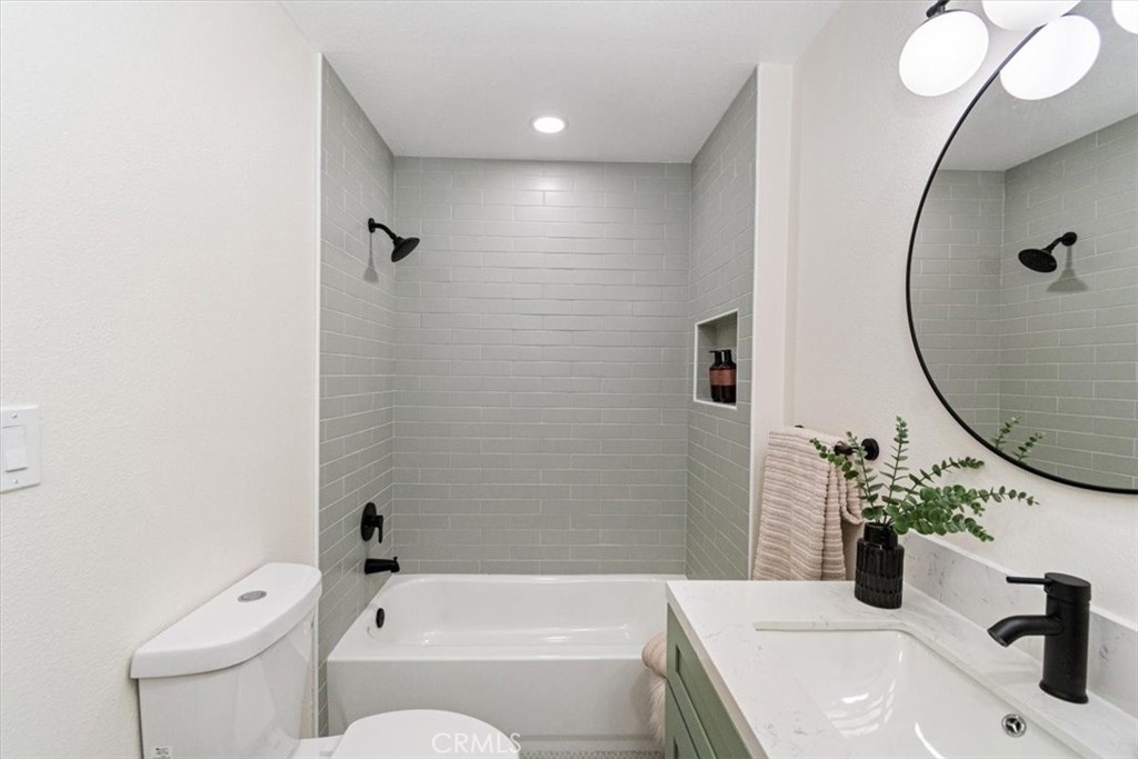 4474 Highland Place Riverside, CA 92506 - Photo 22 of 31 a bathroom with a sink a toilet and shower