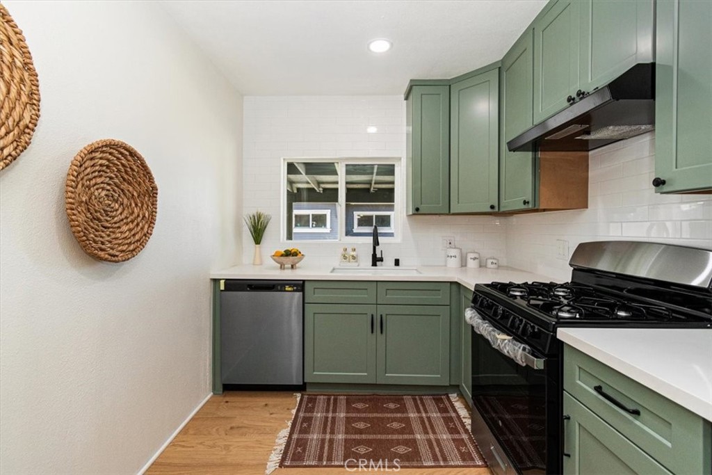 4474 Highland Place Riverside, CA 92506 - Photo 8 of 31 a kitchen with a refrigerator and a sink