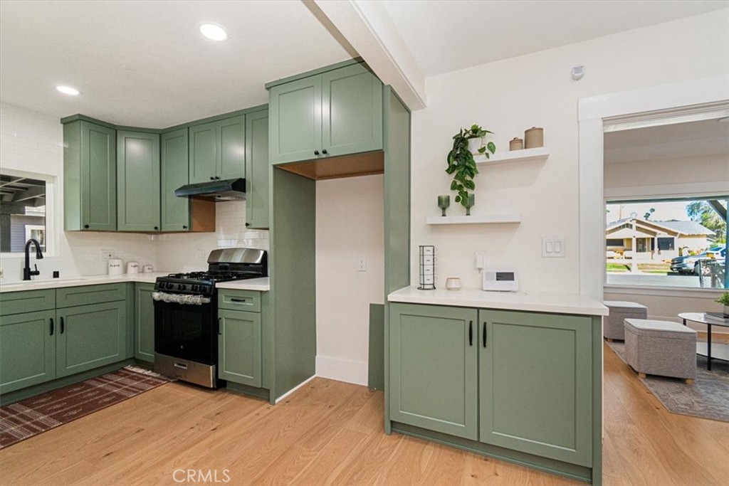 4474 Highland Place Riverside, CA 92506 - Photo 10 of 31 a kitchen with a refrigerator and a sink