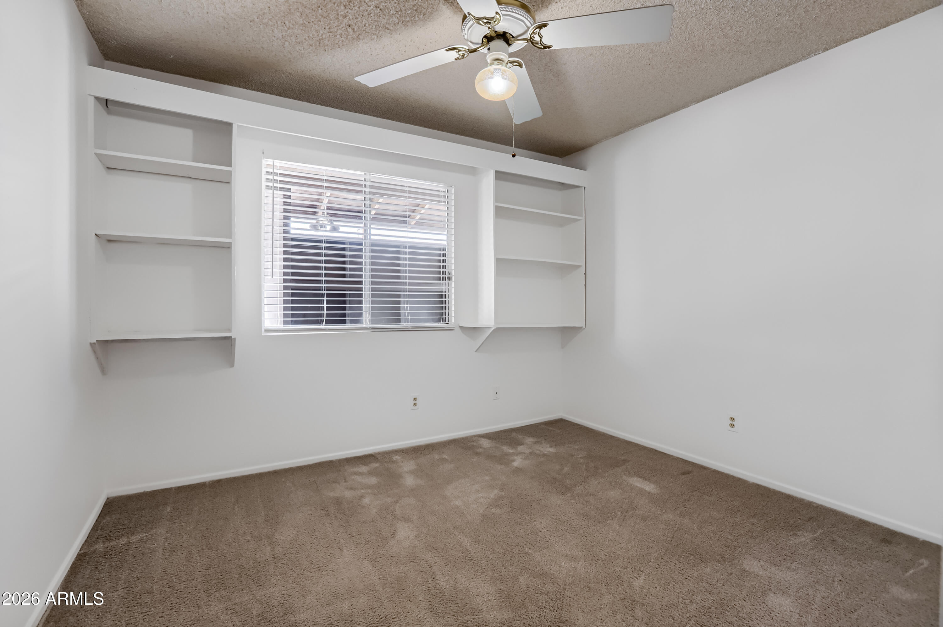 3823 West Greenway Road Phoenix, AZ 85053 - Photo 17 of 28 a view of an empty room with a window