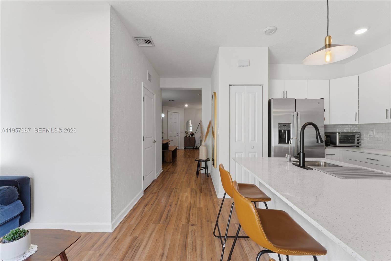 11456 West 33rd Way Hialeah, FL 33018 - Photo 14 of 49 a view of a kitchen with a sink and wooden floor