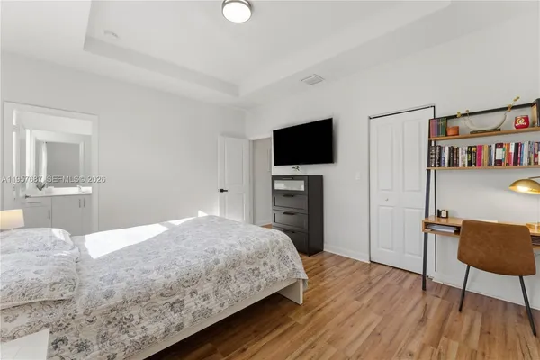 a bedroom with a bed and a flat screen tv