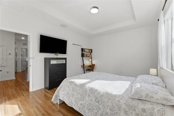 a bedroom with a bed and a flat screen tv