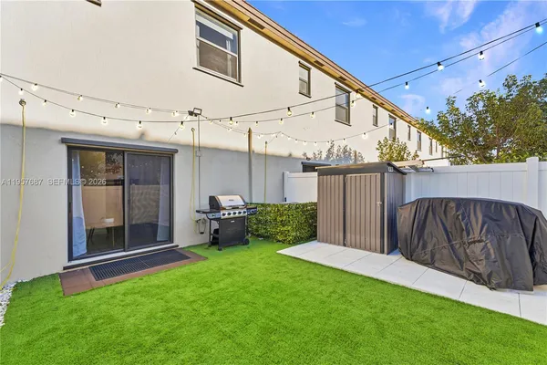 a view of a house with a yard and furniture