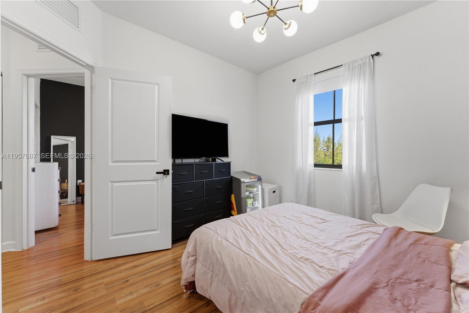 11456 West 33rd Way Hialeah, FL 33018 - Photo 26 of 49 a bedroom with a bed and a flat screen tv