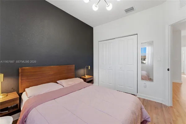 a bedroom with a bed and a chandelier