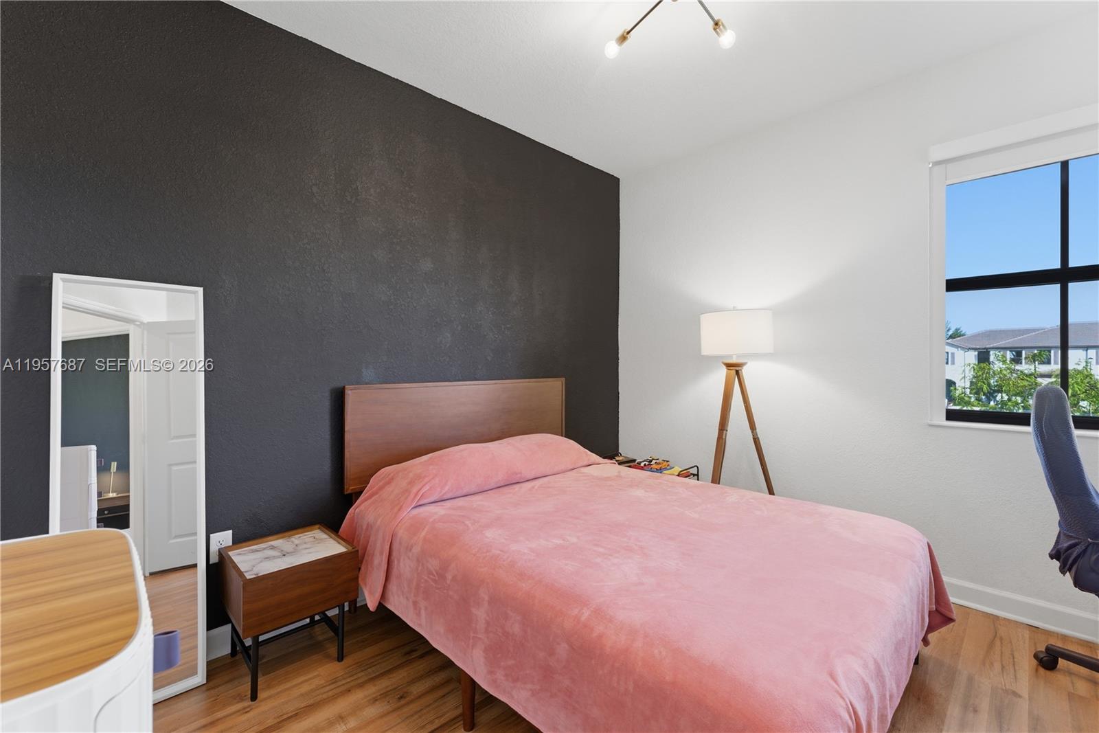 11456 West 33rd Way Hialeah, FL 33018 - Photo 28 of 49 a bedroom with a bed and a potted plant