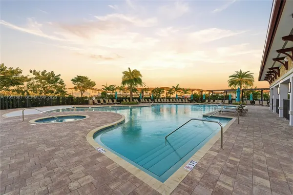 a view of swimming pool with outdoor seating and lake
