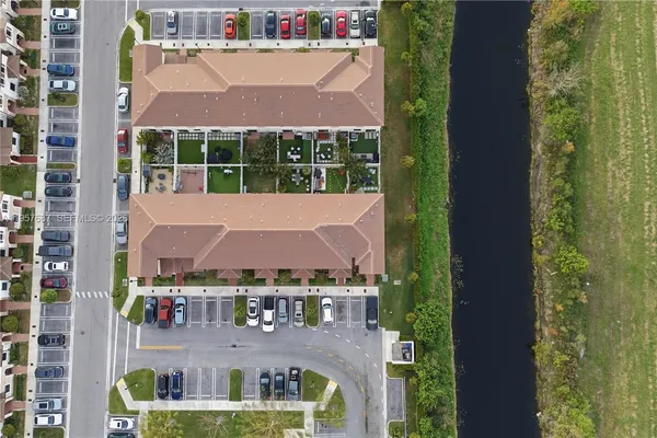 an aerial view of residential houses with outdoor space and street view