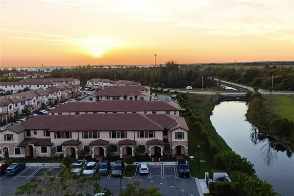 an aerial view of a house with a garden and lake view