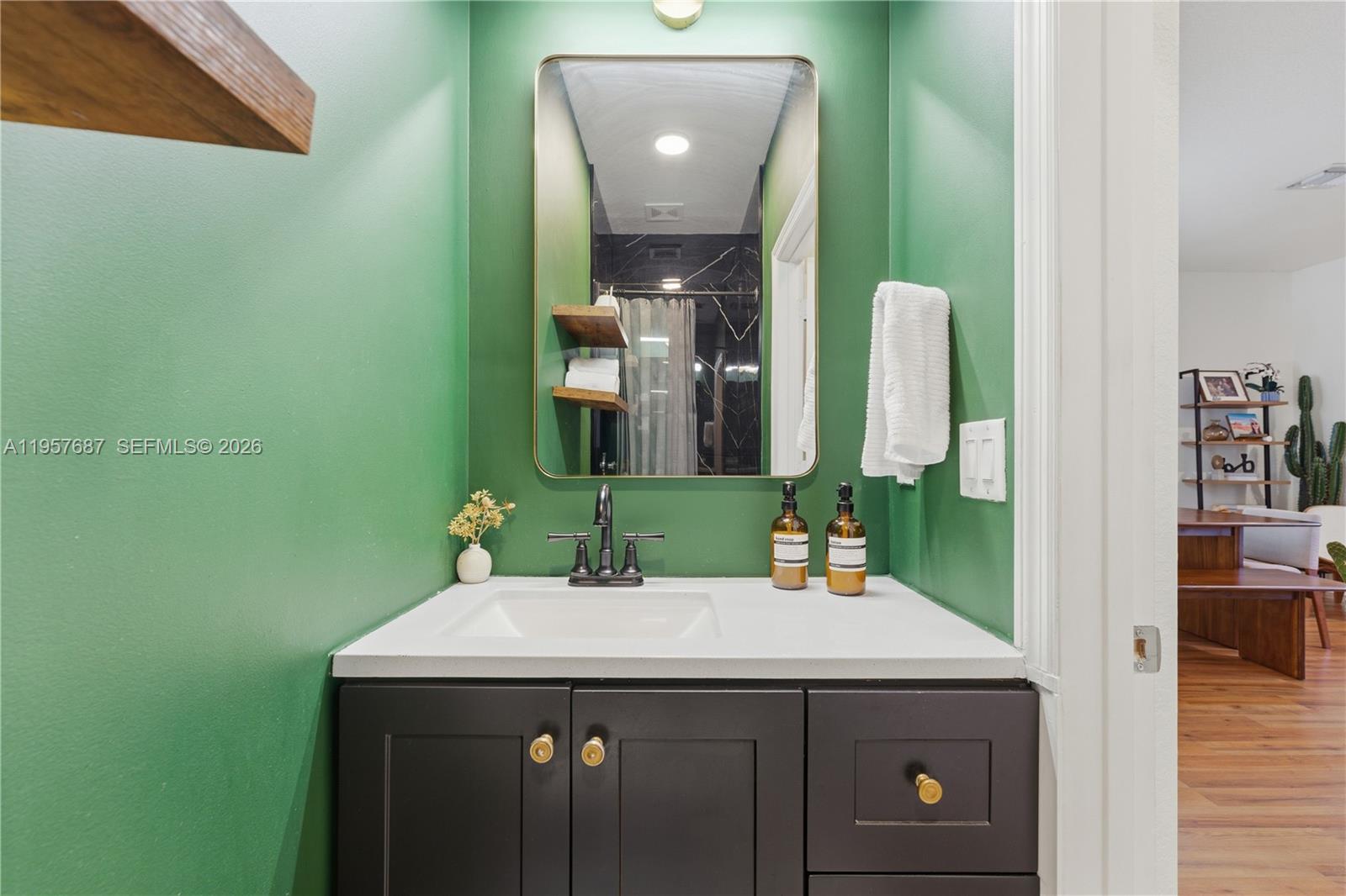 11456 West 33rd Way Hialeah, FL 33018 - Photo 48 of 49 a bathroom with a sink and a mirror