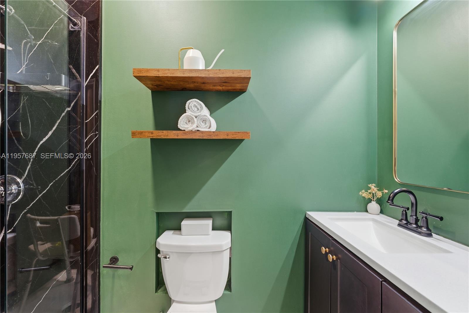 11456 West 33rd Way Hialeah, FL 33018 - Photo 49 of 49 a bathroom with a toilet sink and mirror