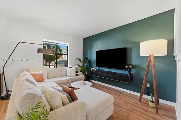 a living room with furniture and a flat screen tv
