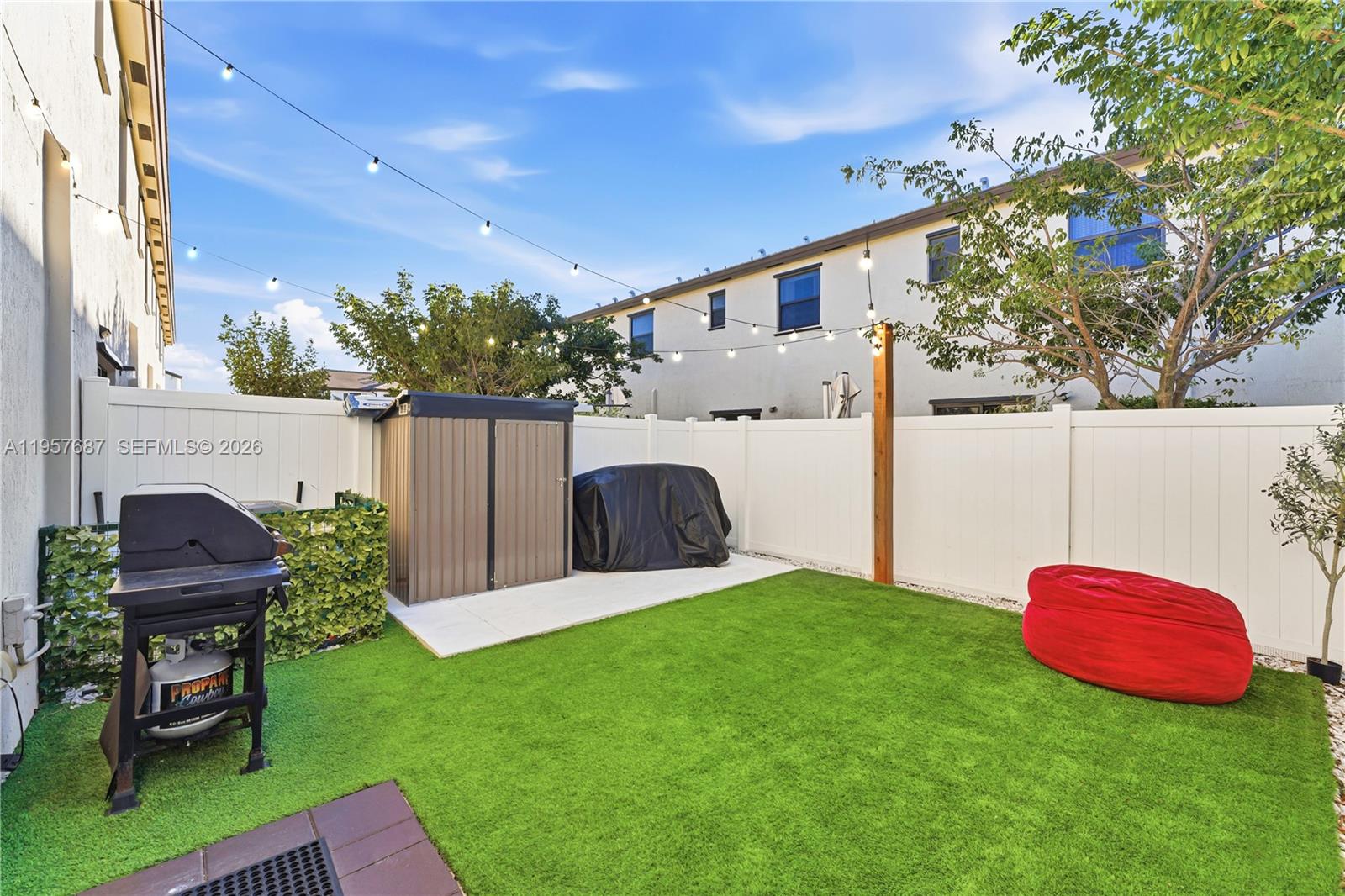 11456 West 33rd Way Hialeah, FL 33018 - Photo 9 of 49 a view of backyard with furniture and a fire pit