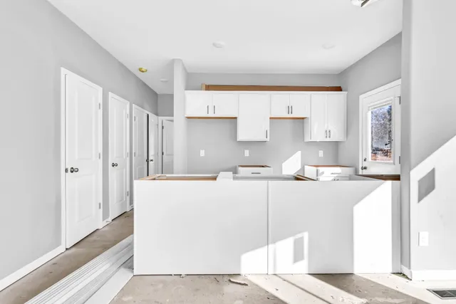 a kitchen with stainless steel appliances granite countertop a refrigerator and a stove