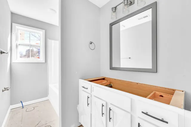 a room that has a dresser in it