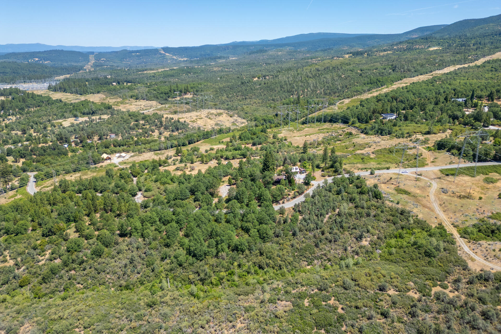 Frisby Road Round Mountain, CA 96084 - Photo 11 of 14 a view of a lush green hillside and houses