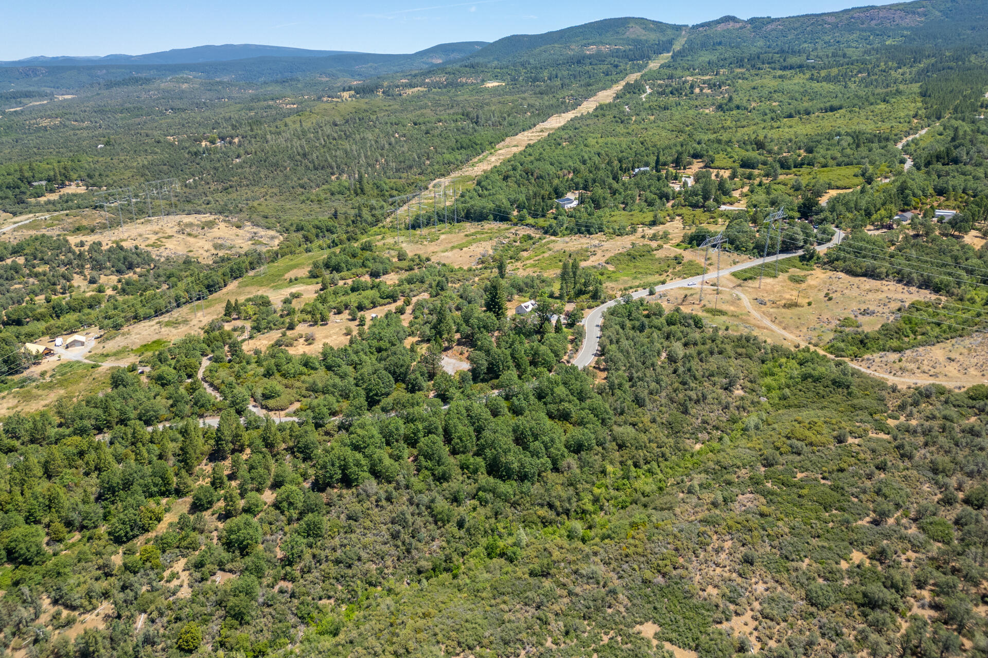 Frisby Road Round Mountain, CA 96084 - Photo 10 of 14 a view of a lush green field with mountains in the background