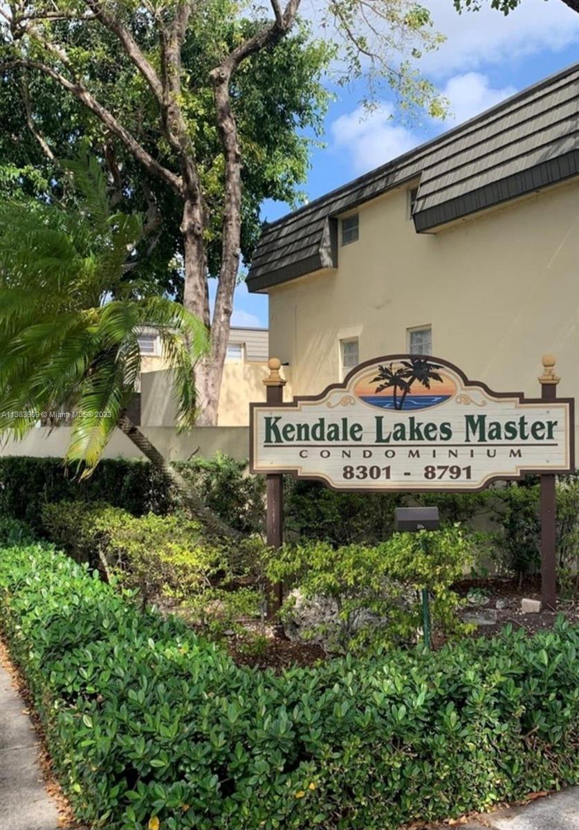 a view of a house with a yard and potted plants