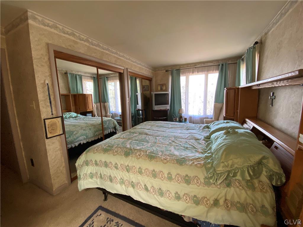 173 Skyview Circle Sciota, PA 18354 - Photo 12 of 25 a bedroom with a bed and glass door