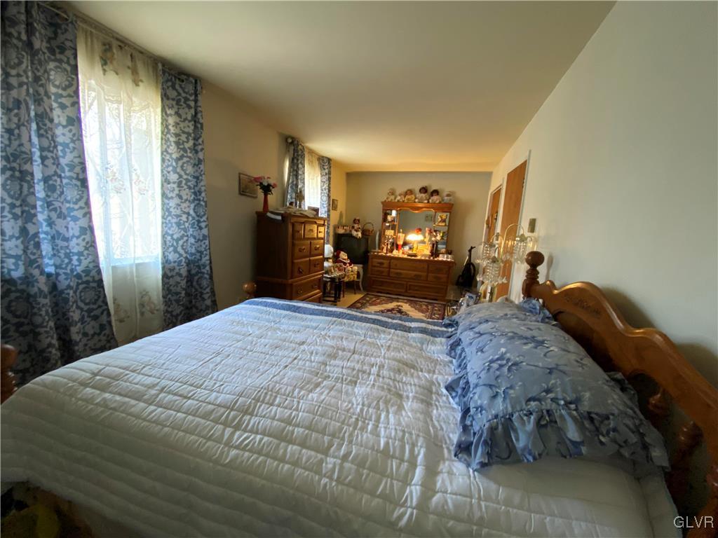 173 Skyview Circle Sciota, PA 18354 - Photo 15 of 25 a bed sitting in a bedroom next to a window