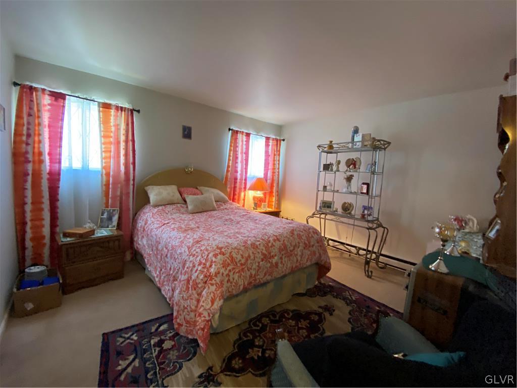 173 Skyview Circle Sciota, PA 18354 - Photo 17 of 25 a bedroom with a bed and a dresser next to a window