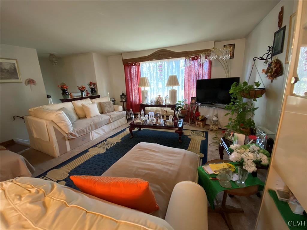 173 Skyview Circle Sciota, PA 18354 - Photo 4 of 25 a living room with furniture a flat screen tv and a large window