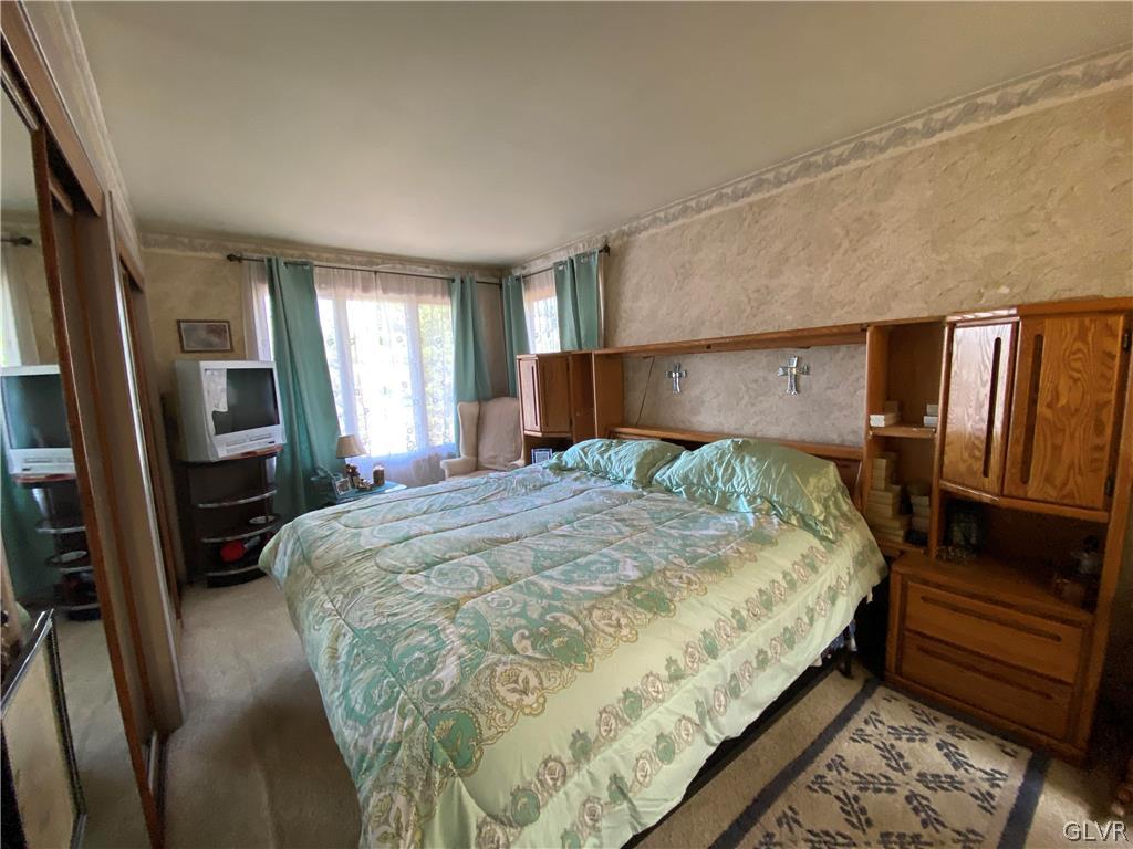 173 Skyview Circle Sciota, PA 18354 - Photo 10 of 25 a bedroom with a bed wooden floor and a flat tv screen on dresser