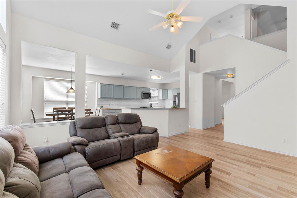 2700 Hereford Road Denton, TX 76210 - Photo 9 of 36 Spacious living area featuring high vaulted ceilings, light wood-finish flooring, and a ceiling fan