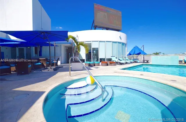 a view of a swimming pool with outdoor seating