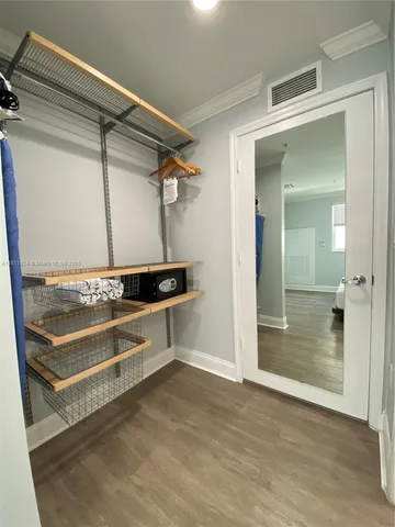 a view of a room with wooden floor