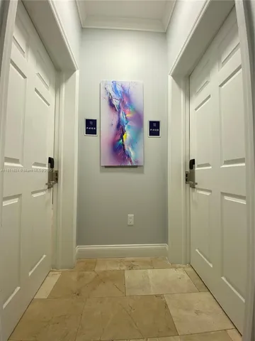 a view of a hallway with paintings on the wall