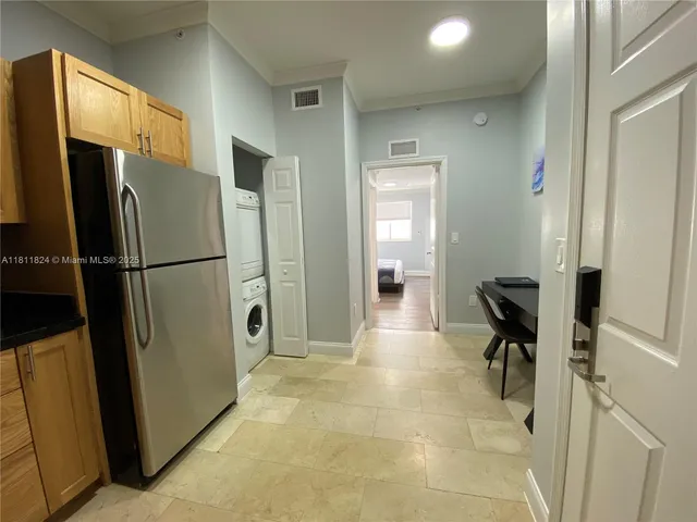 a kitchen with stainless steel appliances a refrigerator and cabinets