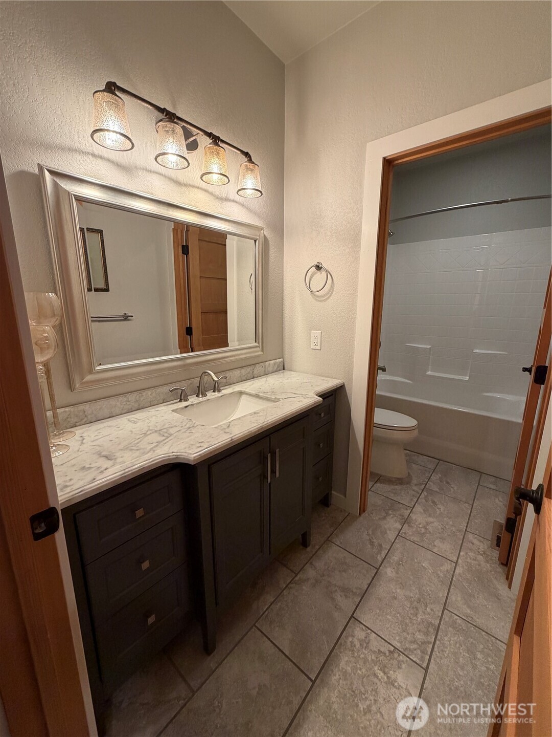 53 Cape Labelle Road Tonasket, WA 98855 - Photo 15 of 40 a bathroom with a granite countertop sink and a mirror