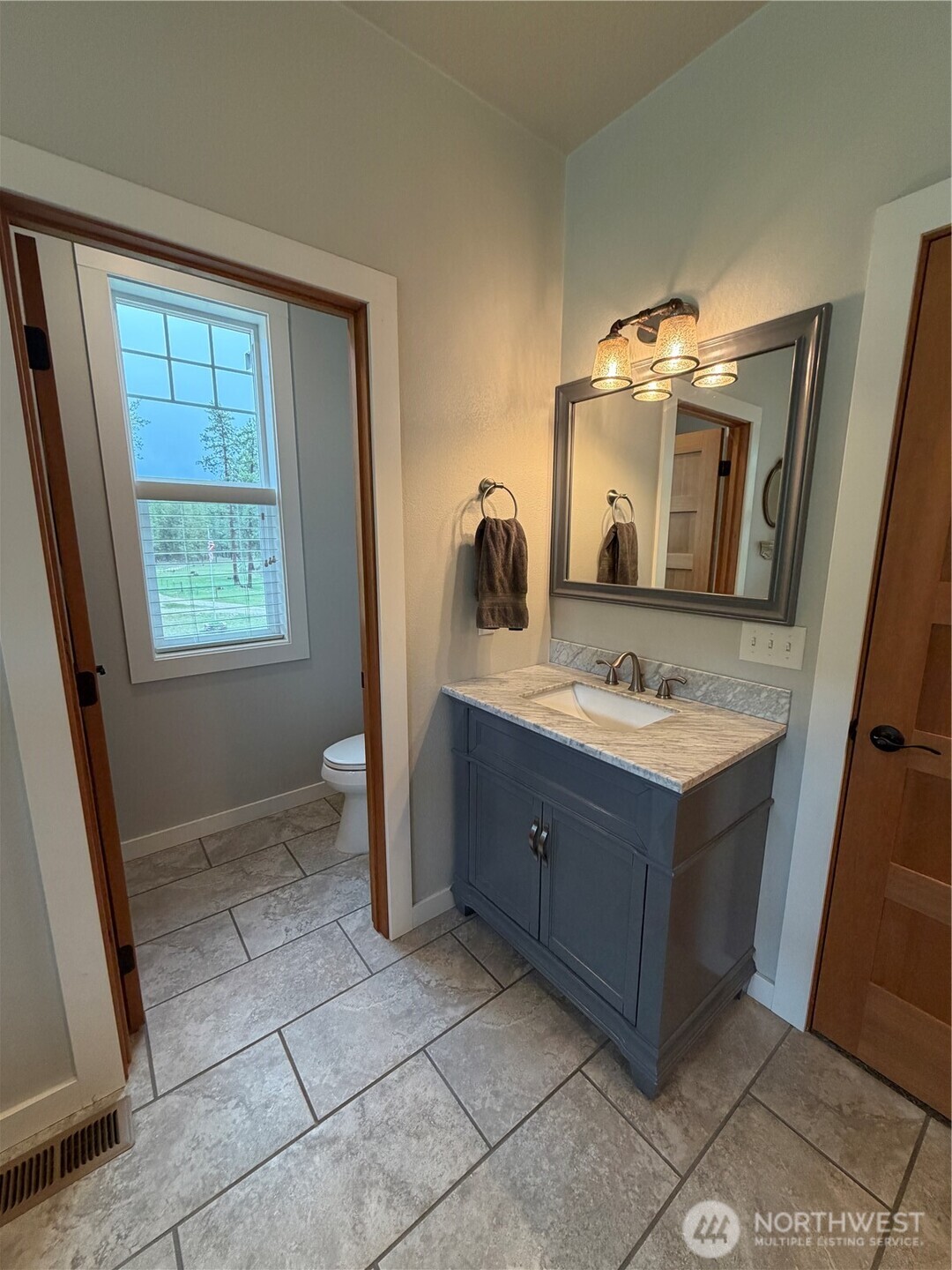 53 Cape Labelle Road Tonasket, WA 98855 - Photo 20 of 40 a bathroom with a sink vanity and mirror