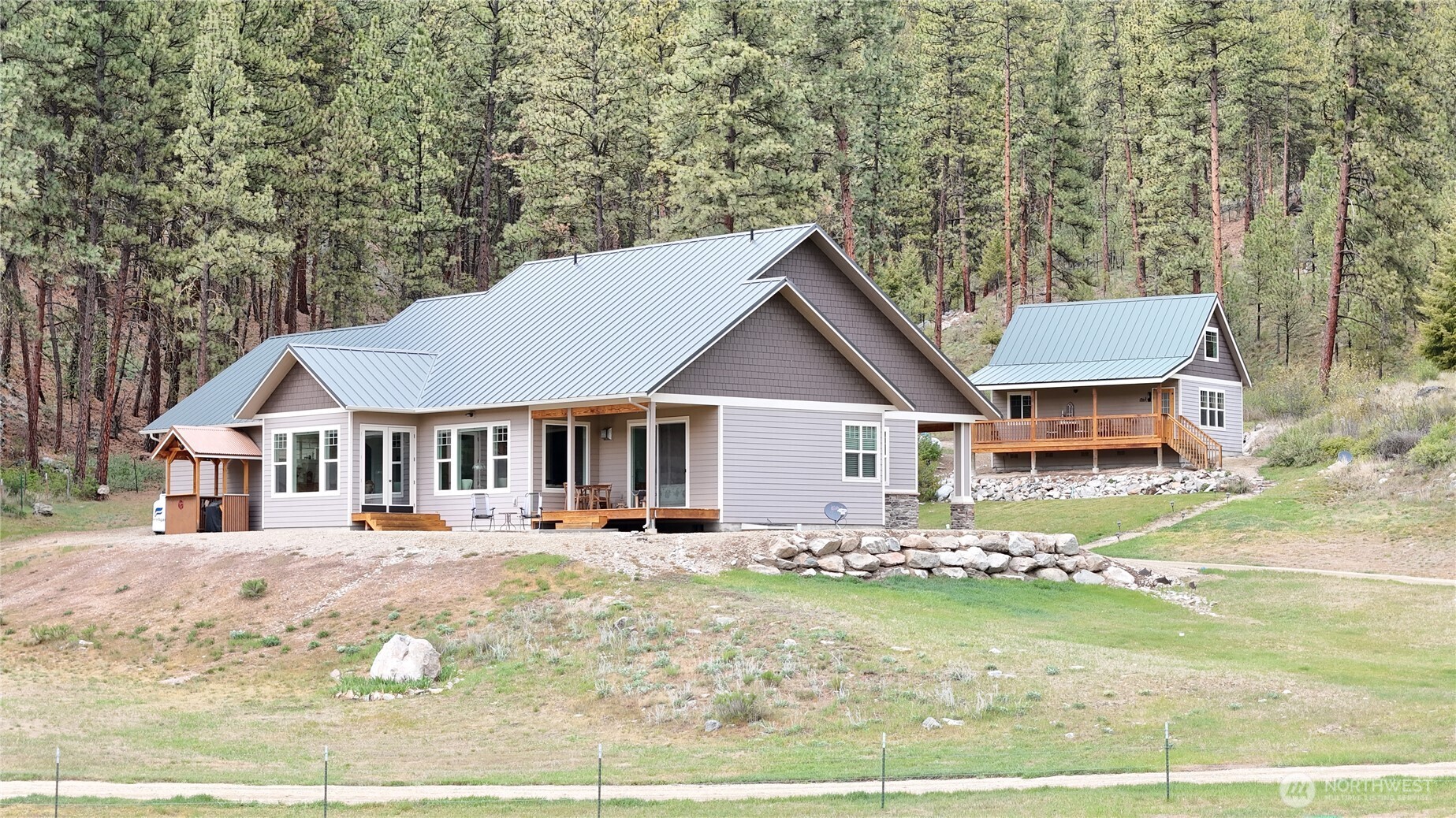 53 Cape Labelle Road Tonasket, WA 98855 - Photo 2 of 40 a front view of a house with a yard