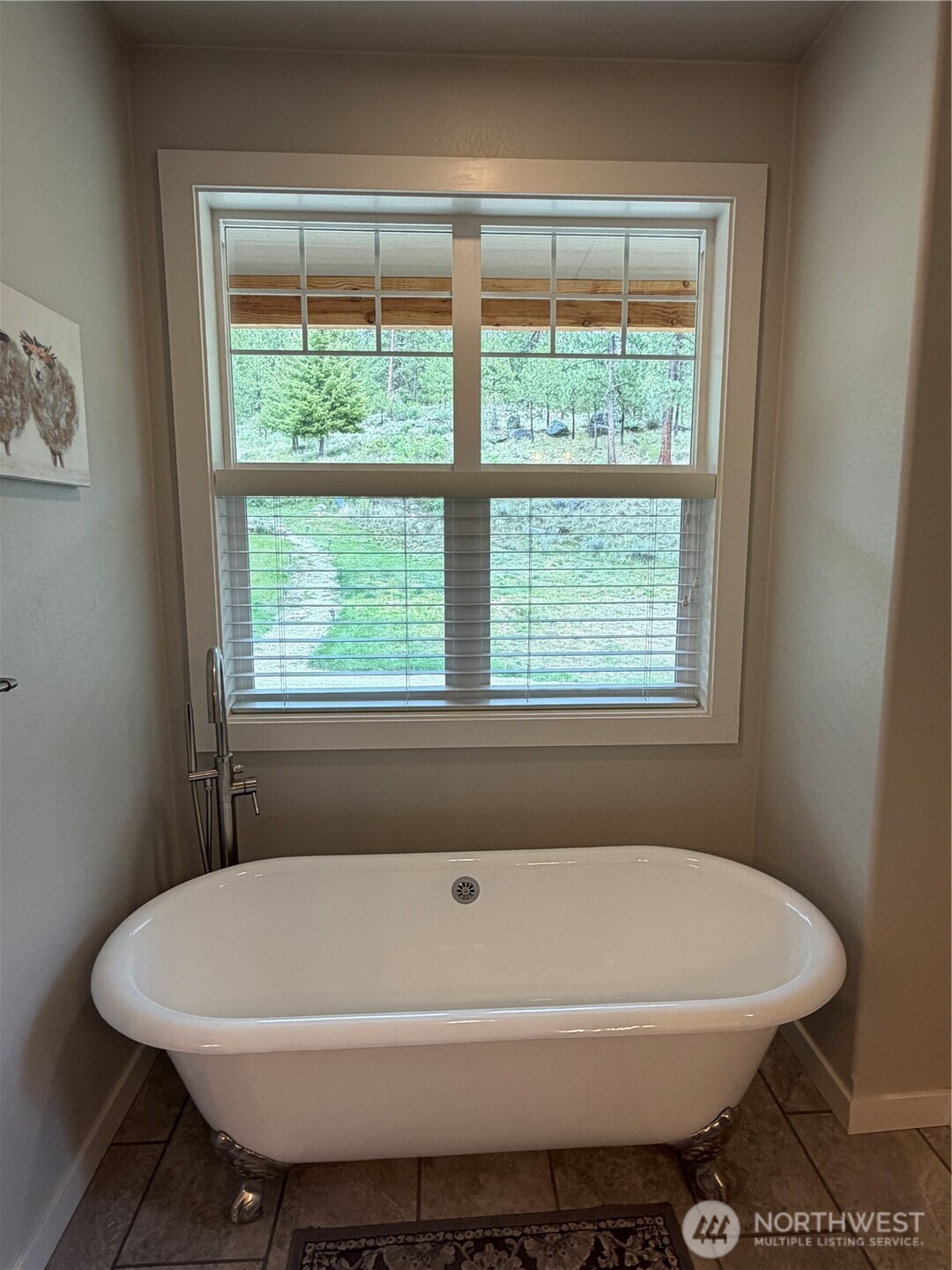 53 Cape Labelle Road Tonasket, WA 98855 - Photo 21 of 40 a white bath tub sitting in a bathroom next to a window