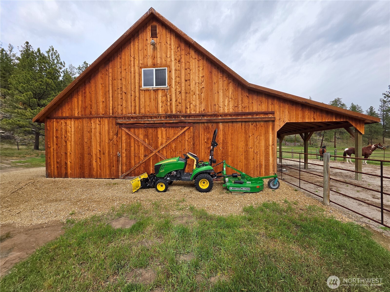 53 Cape Labelle Road Tonasket, WA 98855 - Photo 6 of 40 a backyard of a house with wooden fence and a bench