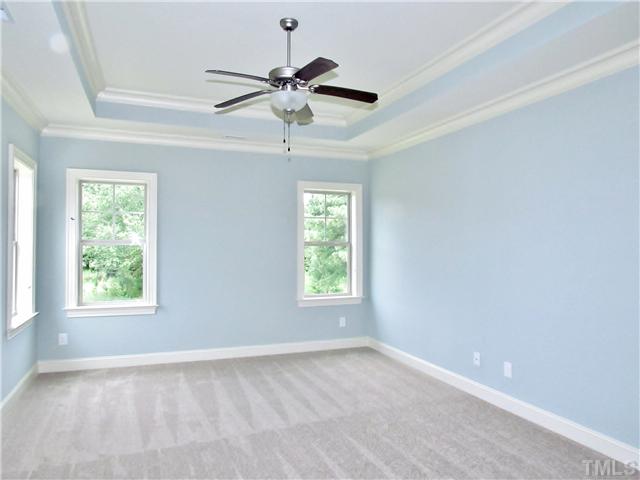 3204 Bryant Falls Court, Unit LOT58 Raleigh, NC 27613 - Photo 11 of 25 an empty room with windows and fan