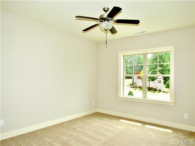 3204 Bryant Falls Court, Unit LOT58 Raleigh, NC 27613 - Photo 19 of 25 an empty room with a window and a fan