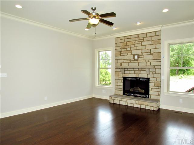 3204 Bryant Falls Court, Unit LOT58 Raleigh, NC 27613 - Photo 4 of 25 a living room with a fireplace and wooden floor