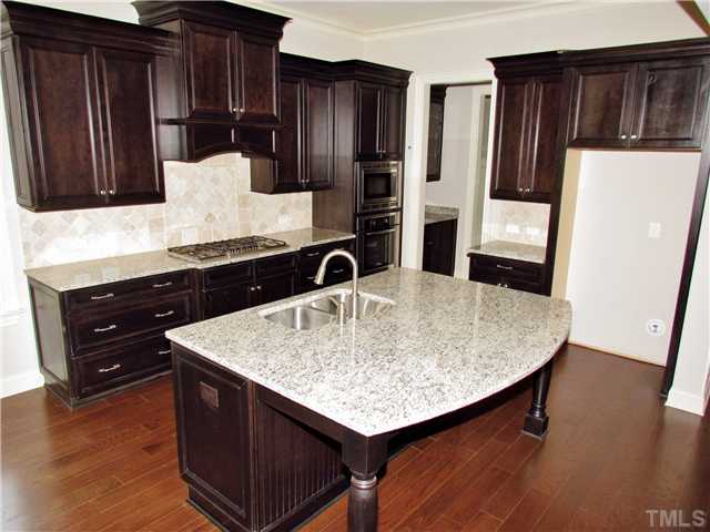 3204 Bryant Falls Court, Unit LOT58 Raleigh, NC 27613 - Photo 7 of 25 a kitchen with stainless steel appliances granite countertop a sink stove and refrigerator