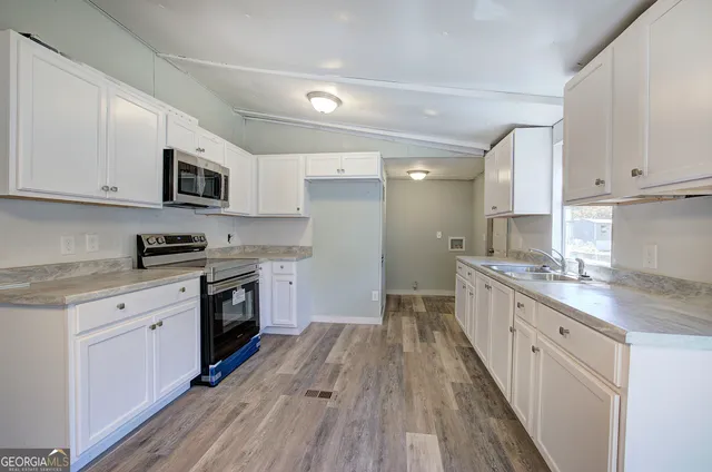 a kitchen with a stove a sink and a refrigerator